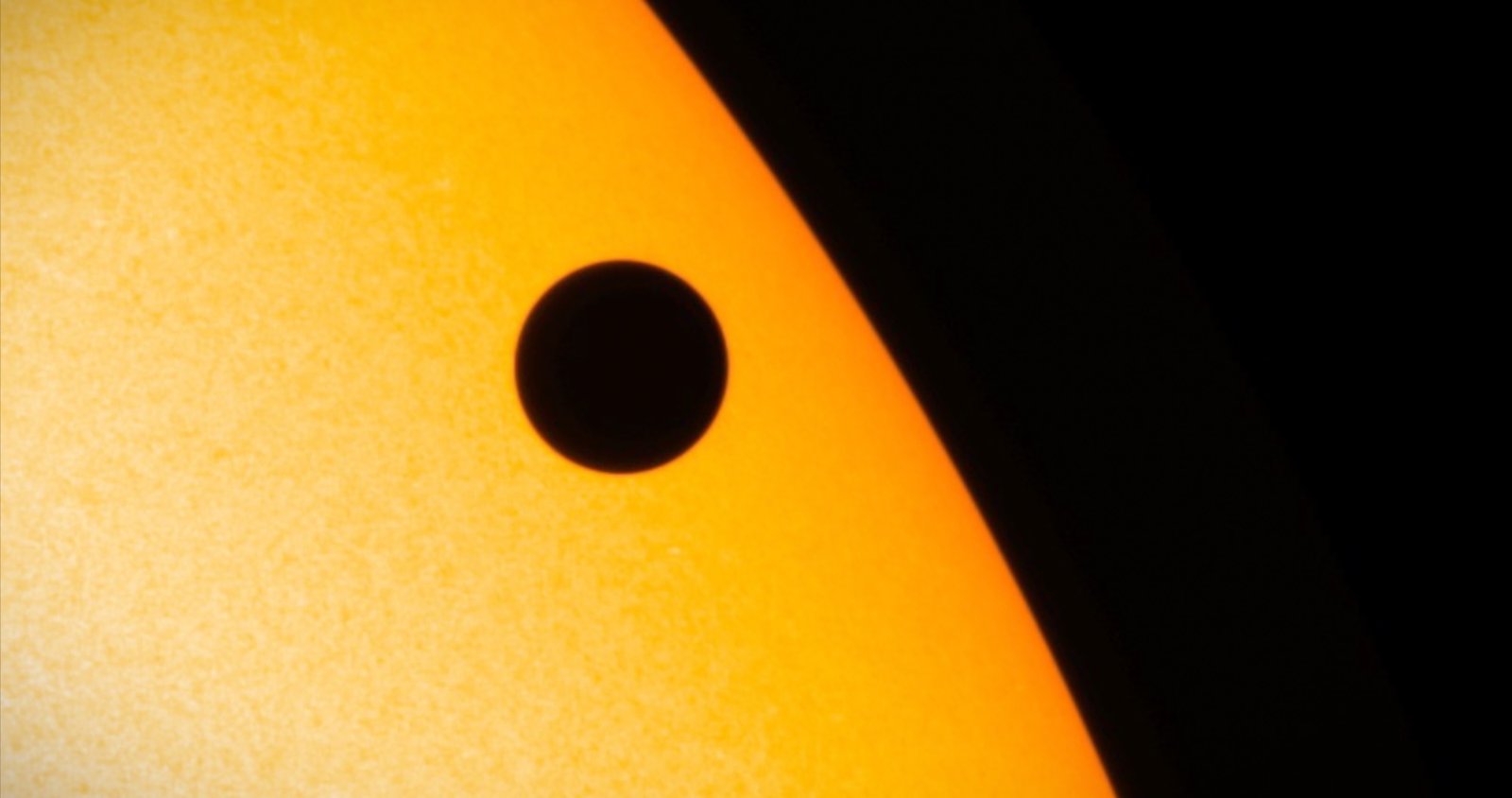 Venus silhouetted as it passes across the glowing face of the sun